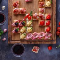 close view of small tapas topped with jamon cured meat and cheese